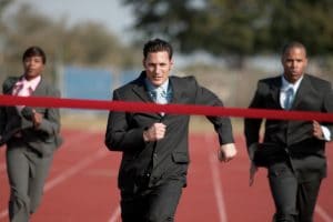 businesspeople running towards finish line